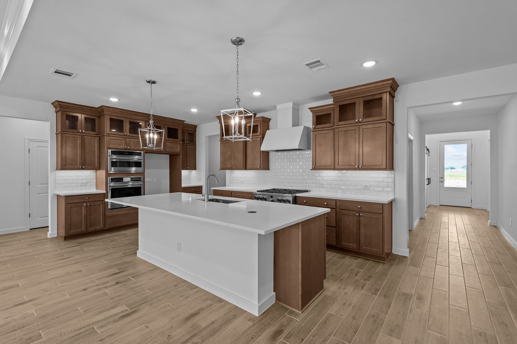 Kitchen features pendant lights over island