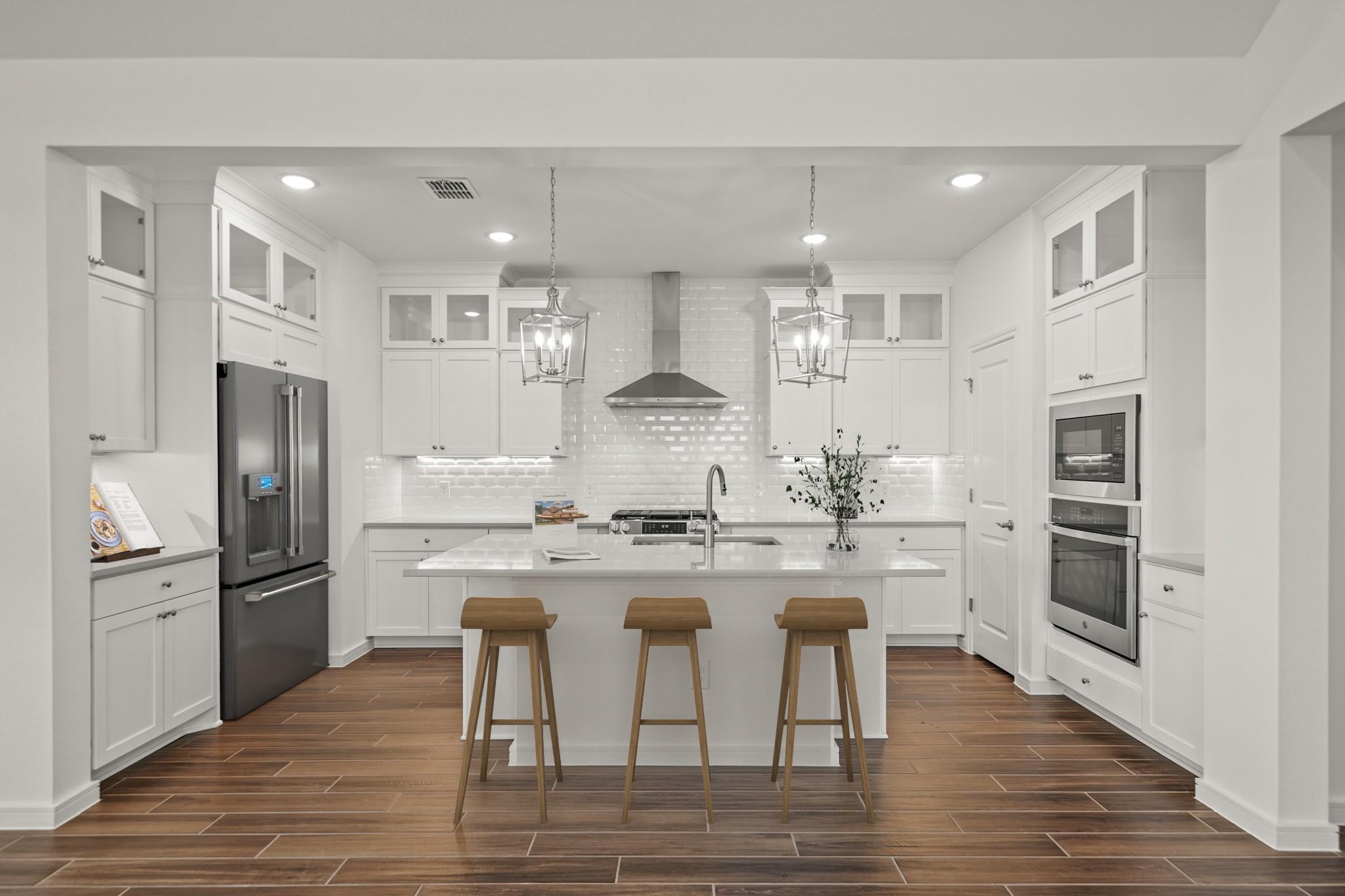 Kitchen with pendant lights & vast island