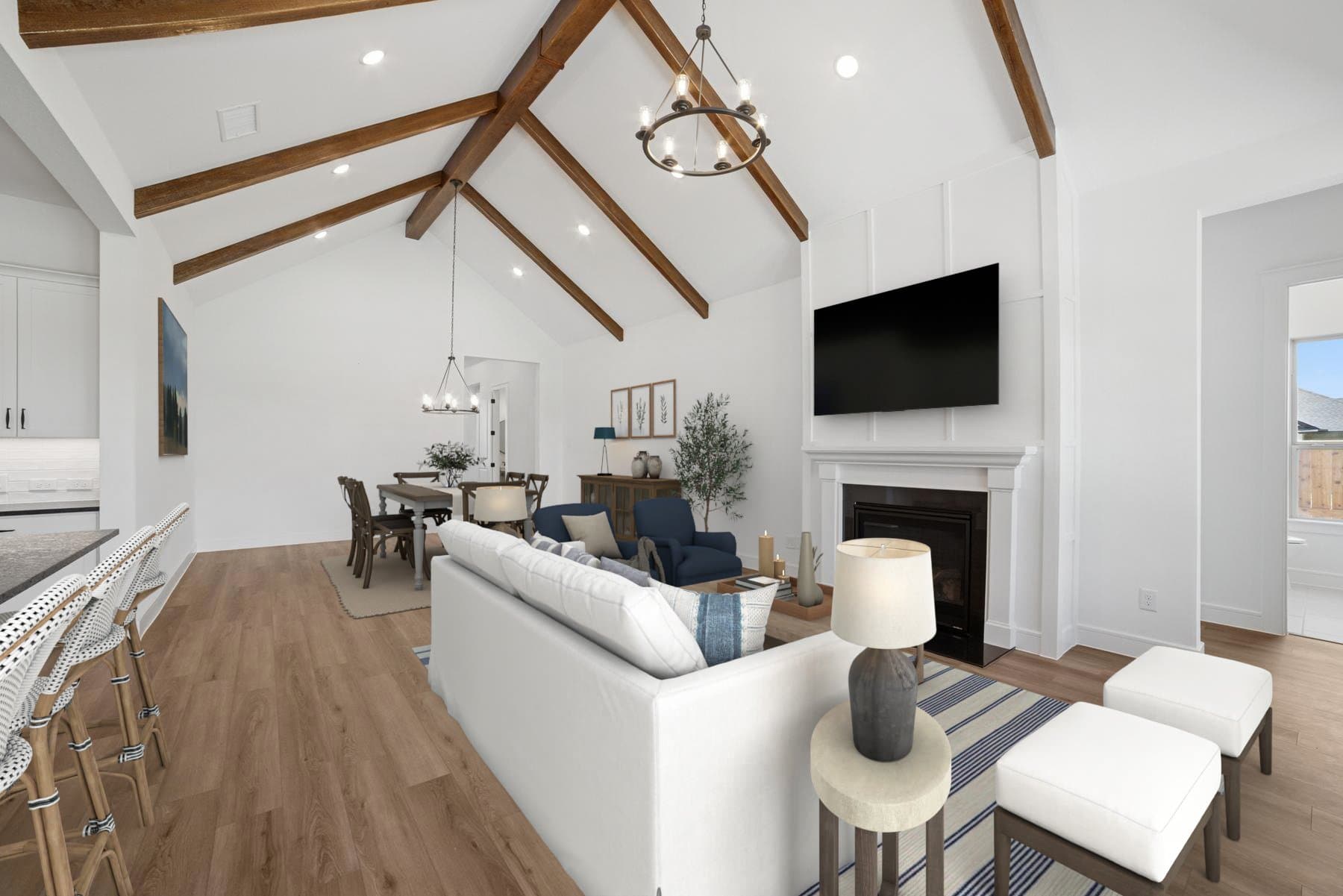 Open concept living spaces with vaulted ceiling & stained ceiling beams