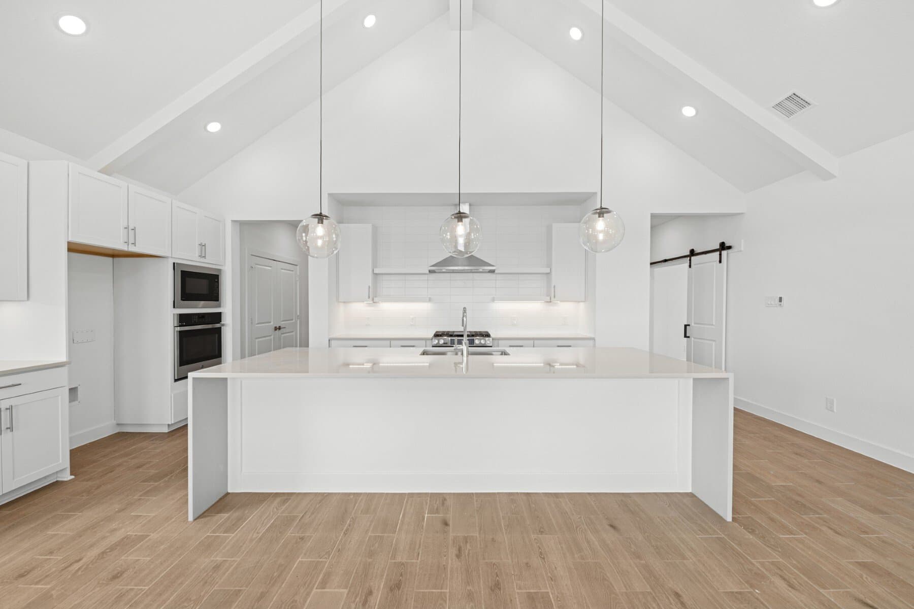 Kitchen with pendant lighting and floating shelves
