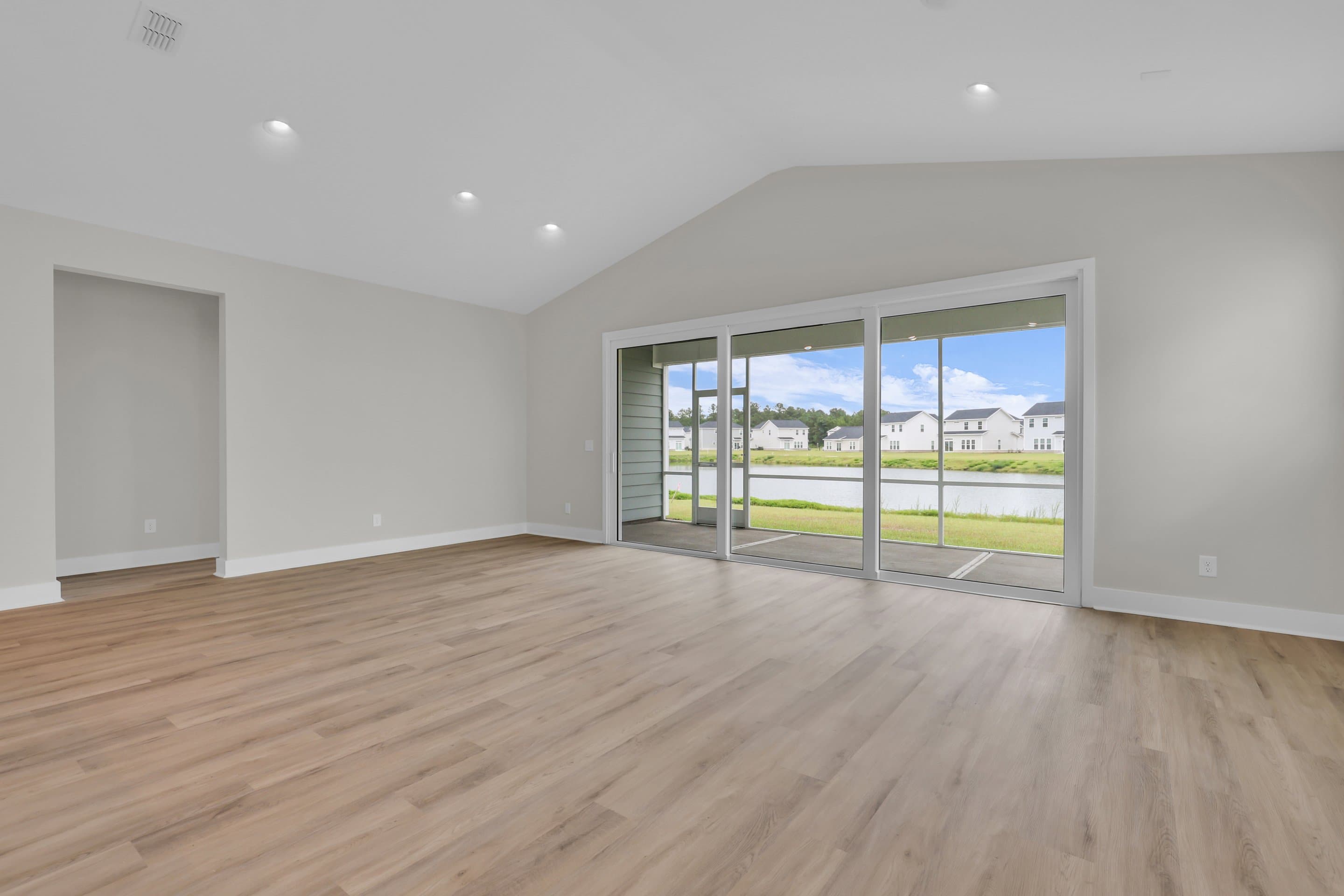 Great room with soaring vaulted ceiling & multi-slide glass door