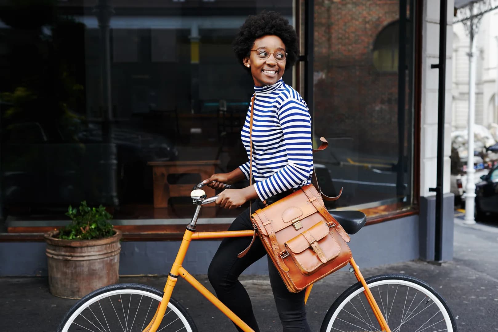Woman Holding Bike in Town
