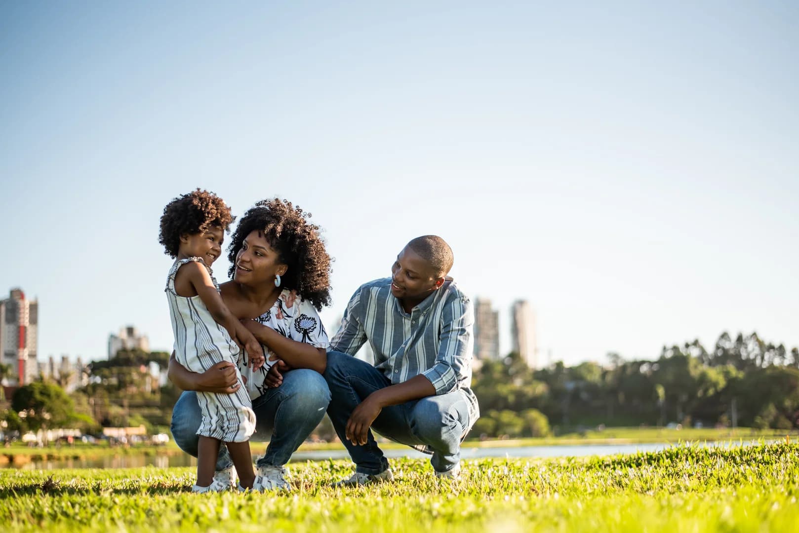 Family strolling in the late afternoon in the city park