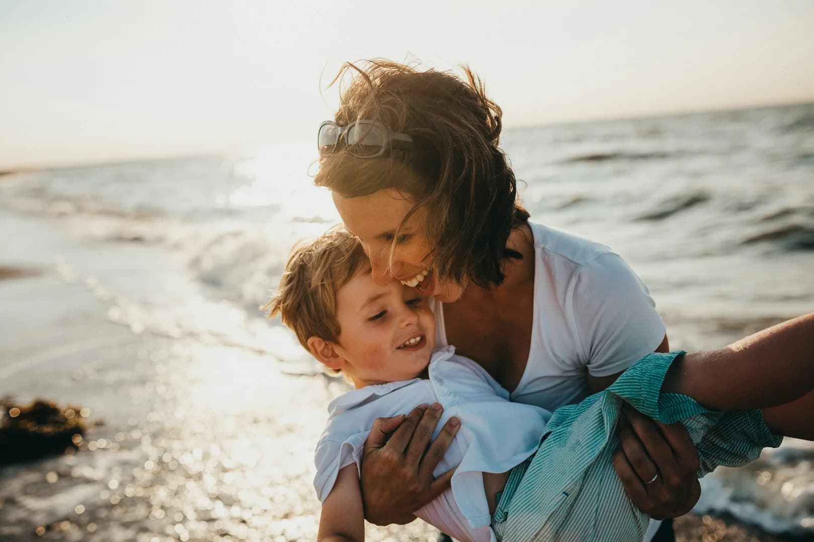 Mother Carrying Son on the Beach