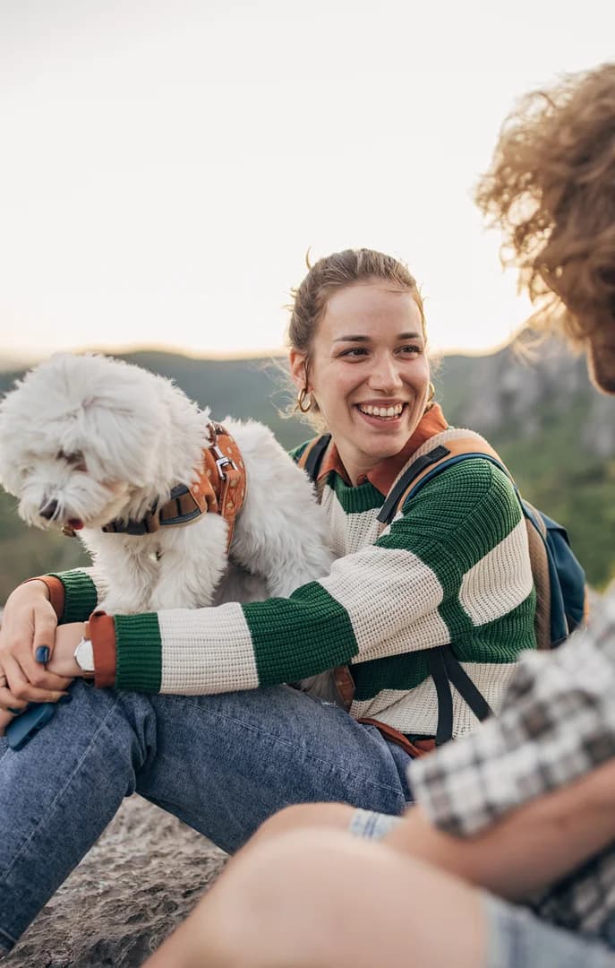 Couple and Their Dog Hiking on a Mountain