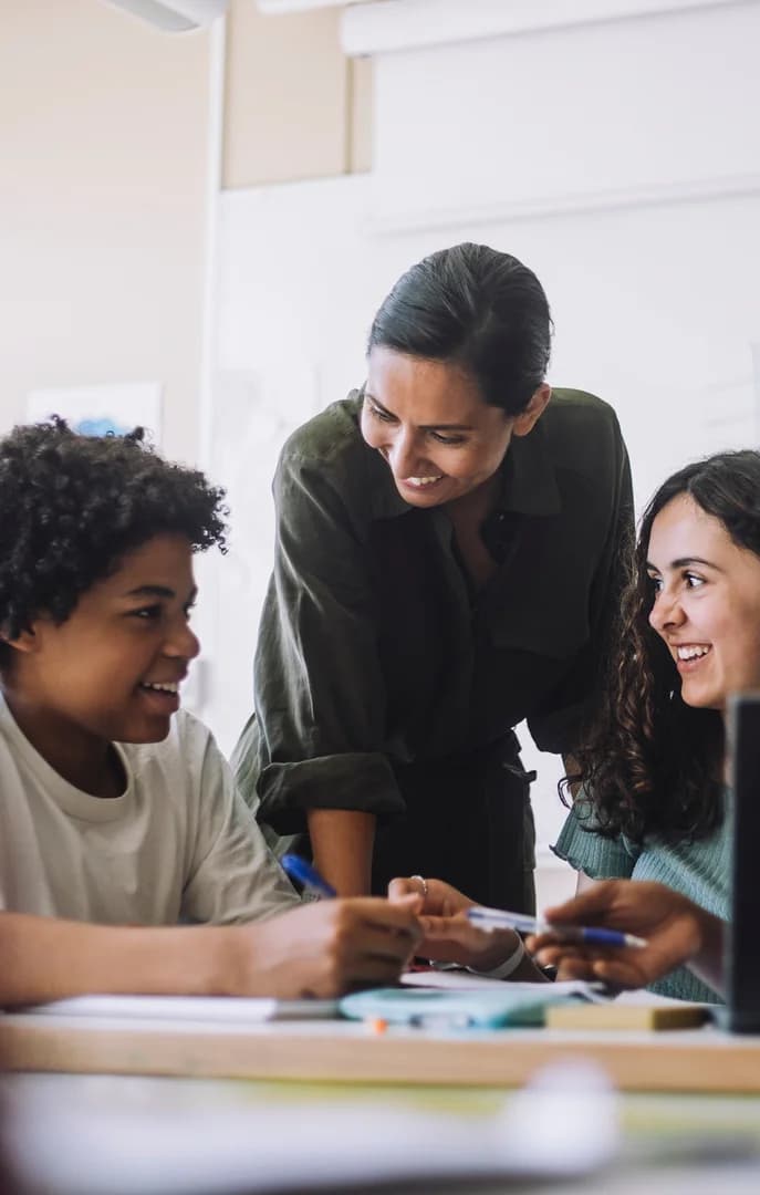 131475 Teacher helping students in schools USP Crop