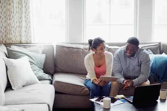 Couple Discussing Finances On The Couch
