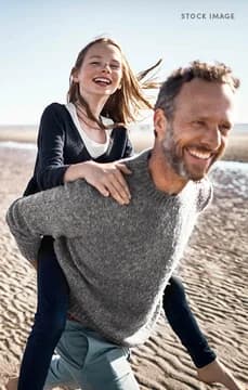 Dad and Daughter Piggyback Ride on the Beach
