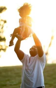 Father and daughter in a field
