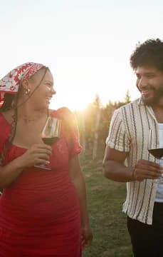 Young Couple of Friends Having a Wine Tasting in Vineyard