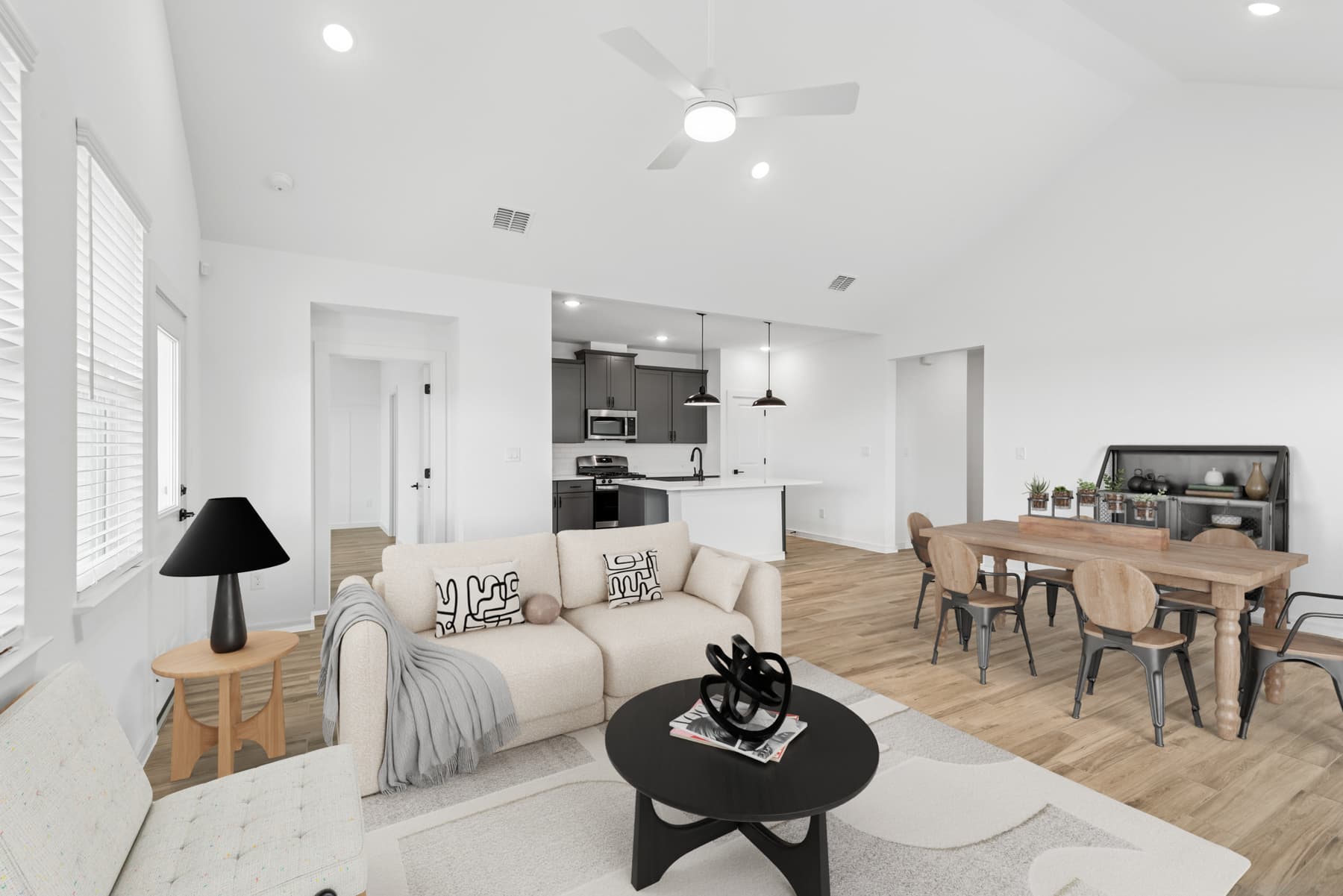 Great room & dining area unite under a soaring vaulted ceiling