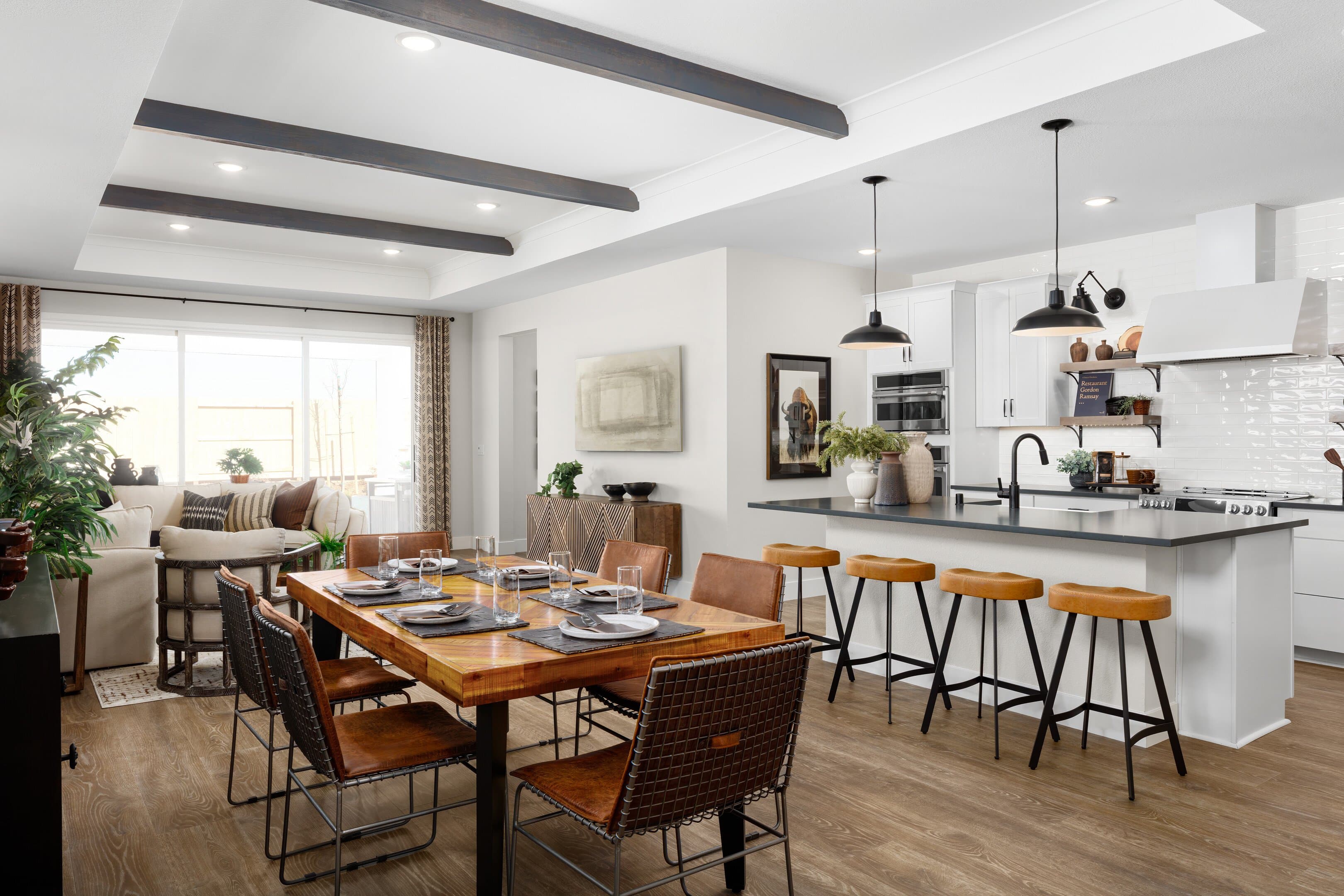 Dining area with stained ceiling beams and gorgeous kitchen