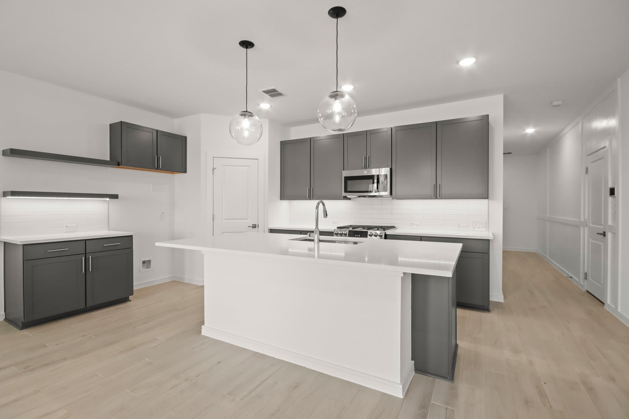 Kitchen with vast island & pendant lights