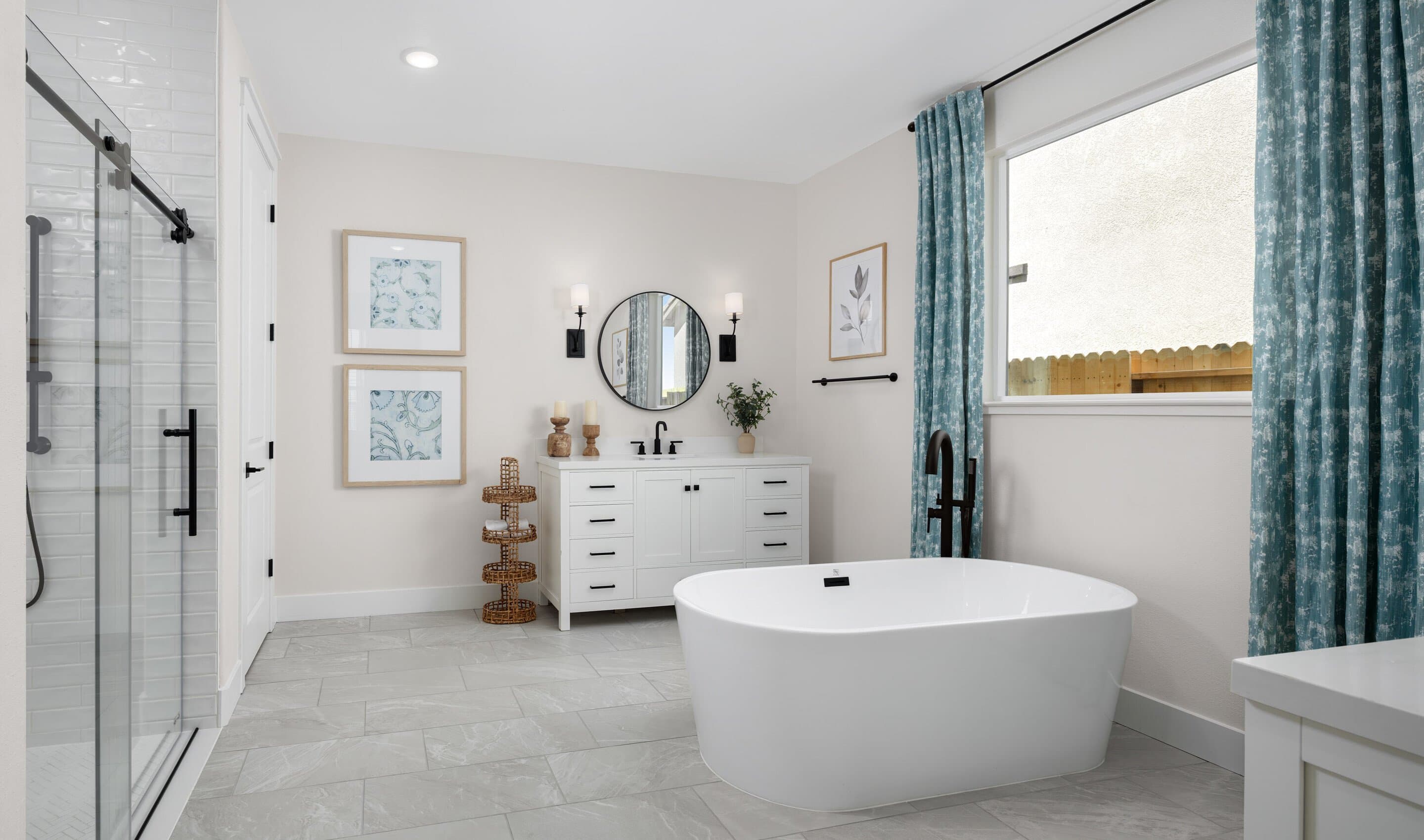 Primary bath with freestanding vanities and tub